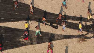 Kids playing and running on the fishing nets