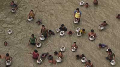 Men and children fishing in the river