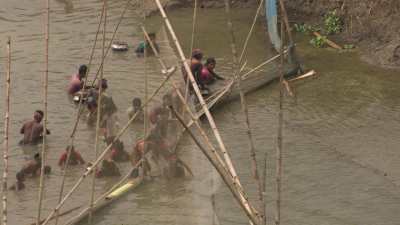 Men and children fishing in the river