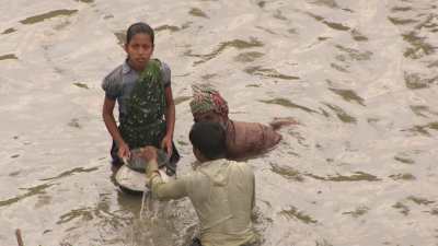 Men and children fishing in the river