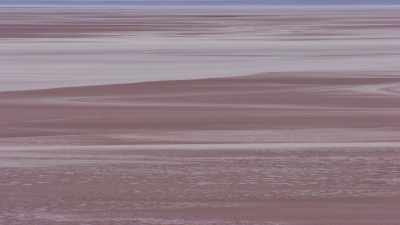 Floght over the Salar, salt piles in the distance