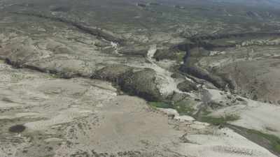 Arid mountains, fertile enclosed valley, lake