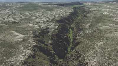 Wide shot of an enclosed  fertile valley