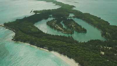 Flight over a thin and long atoll, an abandoned ship