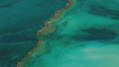 Small islands and rocks appear in turquoise waters