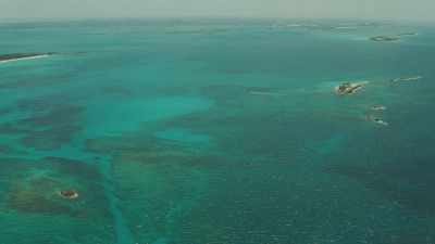 Flight over islands and white sand coves