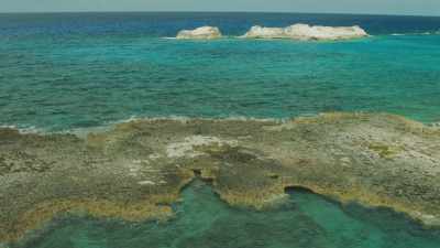 Small rocks showing on shallow waters