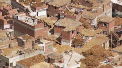 Fodder laying on houses roofs in a village