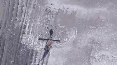 Farmer plows marshy lands with a horse