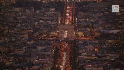 Paris at night with the Triumphal Way and a wide shot on the parisian cityscape