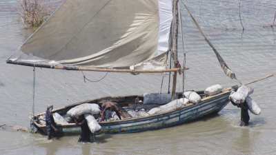 Unloading boats on men's back