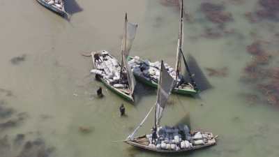 Unloading boats on men's back