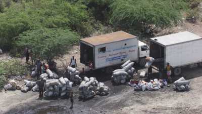 Flooded houses, unloaded boats, trucks waiting