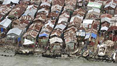 The wretched Cite Soleil environment, iron roofs and small boats