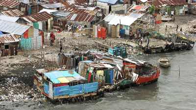 The wretched Cite Soleil environment, iron roofs and small boats