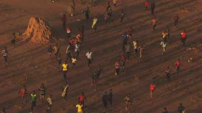 Man and children rush up when hearing helicopter,IFO Camp