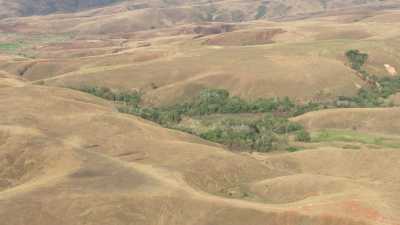 Over arid hills, a village