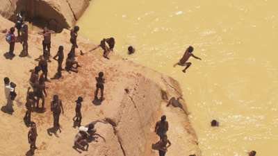 Children games in the yellow mine sites waters