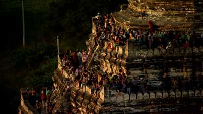 Tourists and monks on Bagan temples sides