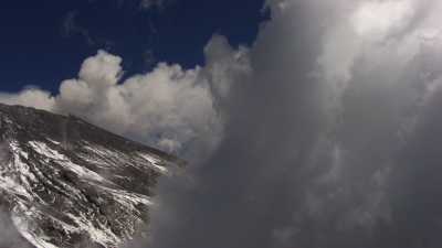 The snowy Popocatepetl, surrounded by blue sky and clouds