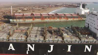 Close shots of a ship waiting to be deconstructed on the shore