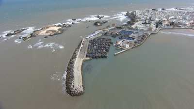 Floght over the fishing harbour, of the city and beach