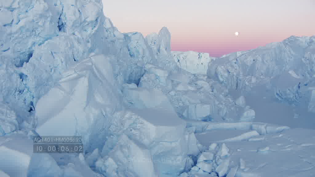 Spectacular flight through a canyon on the Astrolabe Glacier at dusk in summer.