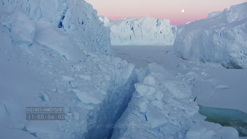 Spectacular flight through a canyon on the Astrolabe Glacier at dusk in summer.