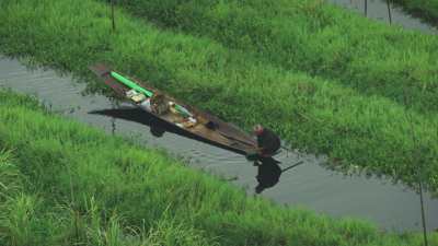 Farmers in dugout canoes